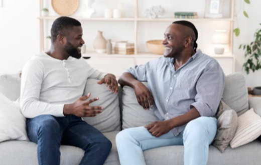 A photo of two men having a chat