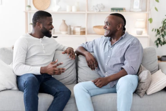 A photo of two men having a chat