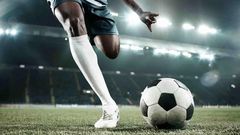 A person kicking a soccer ball