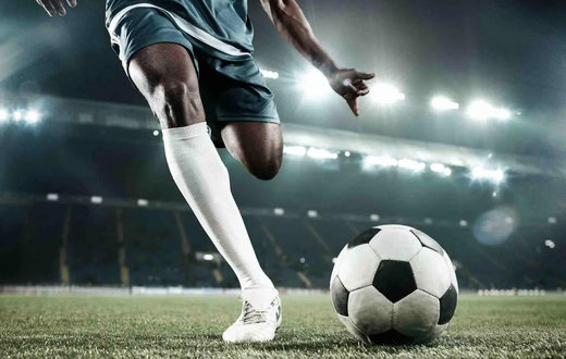 A person kicking a soccer ball