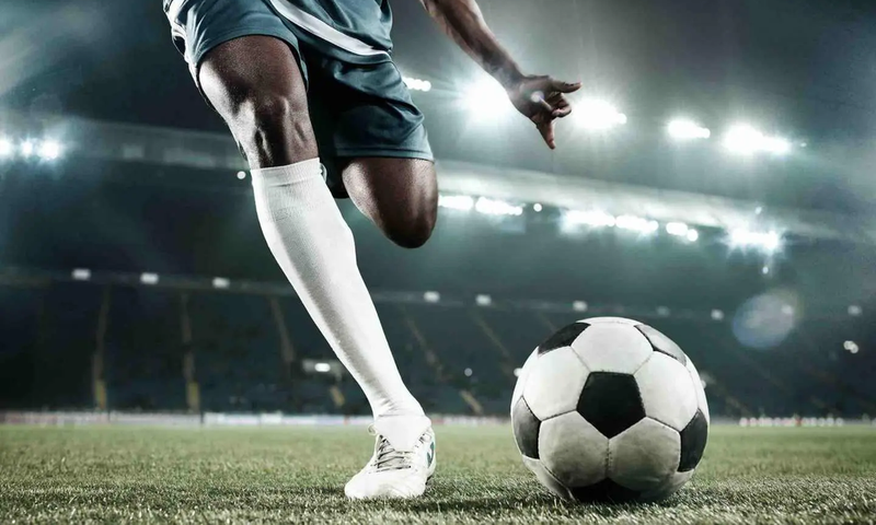 A person kicking a soccer ball