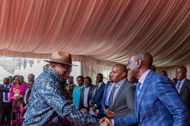 Former President Uhuru Kenyatta greeting President William Ruto during Ordination and Installation ceremony of Bishop Peter Kimani in Embu