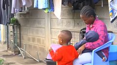 Fred Mosoti's wife, Veronica Oruta with their two children during an interview following his disappearance