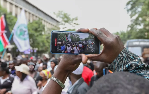 A photo of a person recording a video on their phone