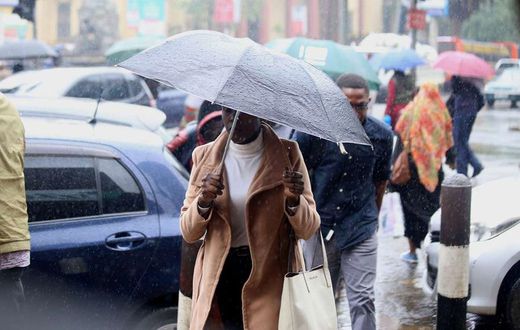 Kenyan experiencing rainfall in Nairobi