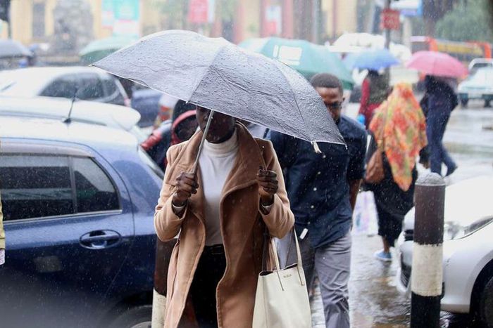 Kenyan experiencing rainfall in Nairobi