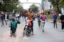 Armed goons pictured walking in the streets of Nairobi during protests earlier this week