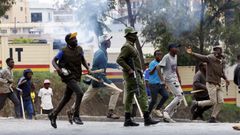 Armed goons pictured walking alongside the police in the streets of Nairobi during protests in Nairobi earlier in June