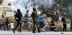 Armed goons pictured walking alongside the police in the streets of Nairobi during protests in Nairobi earlier in June