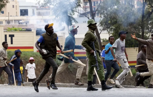 Armed goons pictured walking alongside the police in the streets of Nairobi during protests in Nairobi earlier in June