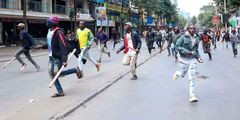 Armed goons pictured walking in the streets of Nairobi during protests earlier this week
