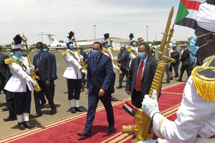 Hamdok (centre right) welcomes Madbouli (centre left) in Khartoum. It is Madbouli's first official visit to Sudan since the formation of its transitional government in 2019
