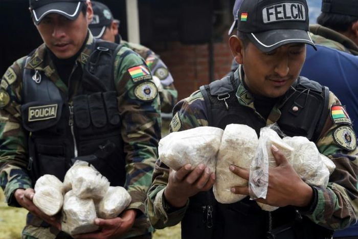 Anti-narcotics police officers prepare to incinerate cocaine at La Rinconada, in outskirts of La Paz, on December 5, 2019