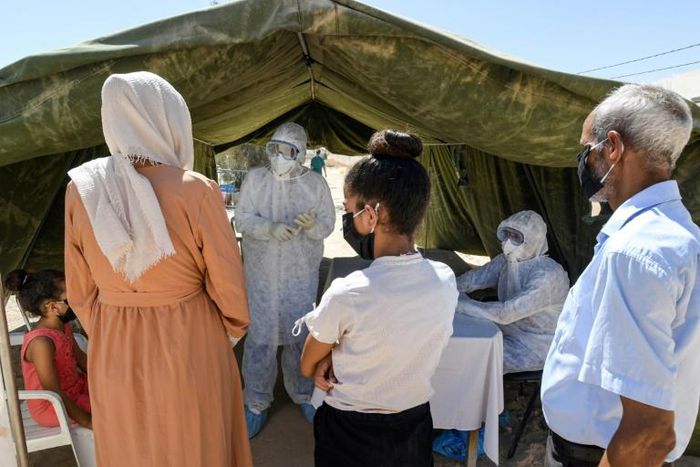 People queue to get tested for coronavirus at the field hospital in El Hamma. The town's hospital has no intensive care beds, and the army set up the field hospital in mid-August to bolster the local response and screen suspected cases
