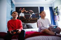 Walton (right) and and his twin brother Jaden &quot;Jdub&quot; Walton play video games in Wannas room at thier home in Winder, Georgia.