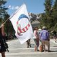A Donald Trump supporter holding a QAnon flag at Mount Rushmore National Monument in South Dakota