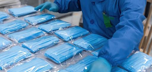 A worker sorting through PPEs