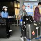 A worker sprays sprays hand sanitizer onto passengers arriving in March 2020 at Taoyuan Airport in Taiwan, one of the few places for which the United States has completely lifted its warning to avoid travel due to the coronavirus
