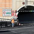 A worker walks near a tunnel before the opening of the new San Giorgio bridge for vehicles