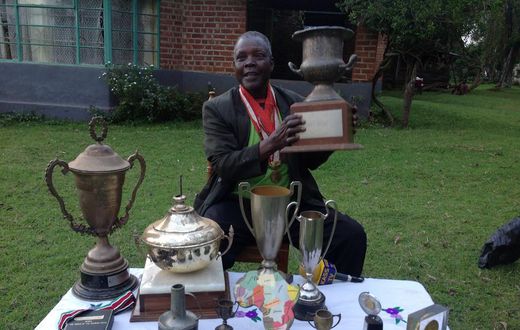 Athletics legend Benjamin Jipcho Chemaima showcasing some of his awards during a past media interview