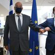 Cypriot Foreign Minister Nicos Christodoulides (R) greets with an elbow bump his Greek counterpart Nikos Dendias in Nicosia