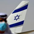 An Emirati official stands near the El Al aircraft which carried a US-Israeli delegation to the UAE on the first ever direct commercial flight following their normalisation accord