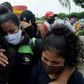 Relatives of a coronavirus victim who died at the start of the pandemic in Ecuador weep as they wait for the recently identified body to be returned to them