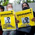 Protesters hold posters showing missing Thai activist Wanchalearm Satsaksit during a rally in Bangkok