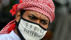 A Muslim wearing a face mask comes out of Masjid-e-Eidgah Bilal after offering prayers during the Eid al-Adha, the feast of sacrifice, in Bangalore on August 1, 2020.
