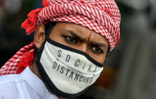 A Muslim wearing a face mask comes out of Masjid-e-Eidgah Bilal after offering prayers during the Eid al-Adha, the feast of sacrifice, in Bangalore on August 1, 2020.