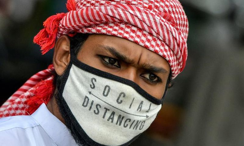 A Muslim wearing a face mask comes out of Masjid-e-Eidgah Bilal after offering prayers during the Eid al-Adha, the feast of sacrifice, in Bangalore on August 1, 2020.