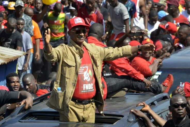 Cellou Dalein Diallo waves to the crowd at a protest against the third term of President Alpha Conde