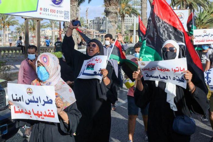 Libyans chant slogans during a demonstration over poor public services at Martyrs' Square in Tripoli on August 25, 2020