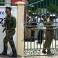 A Sri Lanka Special Task Force soldier stands guard as electoral officials collect ballot papers and boxes from a distribution centre in Colombo
