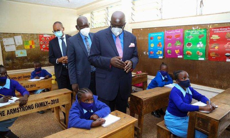 Education CS George Magoha with PS Belio Kipsang at the Olympic Primary School on day 1 of school re-opening following the Covid-19 break