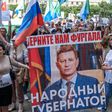 Protestors in the Russian Far East city of Khabarovsk  carry a banner reading "Return Furgal for us", during an unauthorised rally Saturday in support of Sergei Furgal