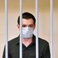 US ex-marine Trevor Reed appeared in a cage for defendants in a courtroom in the Russian capital as the judge read out the guilty verdict