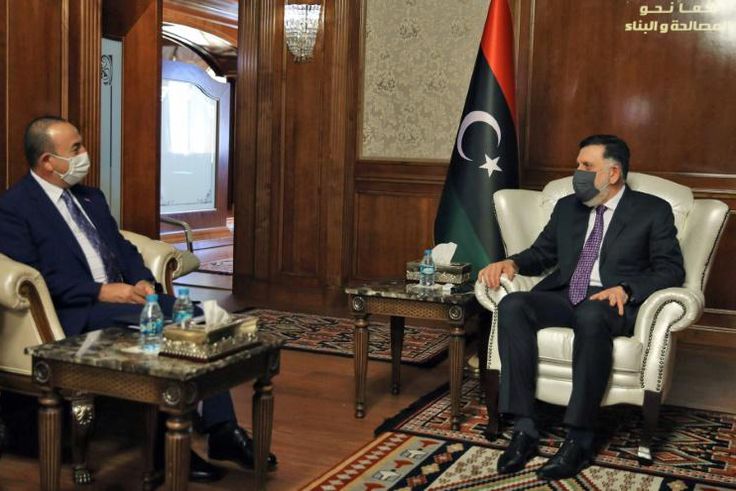 The head of Libya's UN-recognised Government of National Accord Fayez al-Sarraj (R) holds talks in Tripoli with Turkish Foreign Minister Mevlut Cavusoglu whose country backs the GNA in its fight against eastern-based Libya strongman Khalifa Haftar
