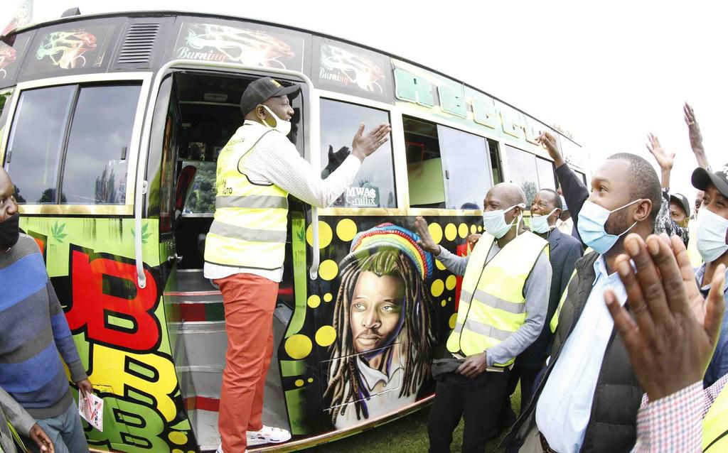 Deputy President William Ruto handing on a matatu