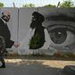 A mural depicts US special envoy Zalmay Khalilzad (L) and Taliban co-founder Mullah Abdul Ghani Baradar. Under the US-Taliban deal, 'intra-Afghan' talks were to start in March but hit delays amid political infighting in Kabul