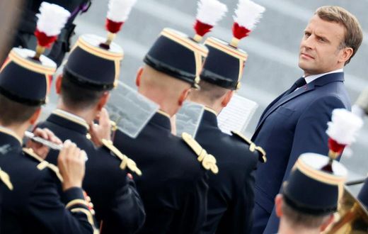 French President Emmanuel Macron reviews the guard of honour during the annual Bastille Day military ceremony in Paris