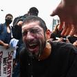 A protester has milk splashed in his eyes after being hit by tear gas during a Black Lives Matter protest in New York on May 29