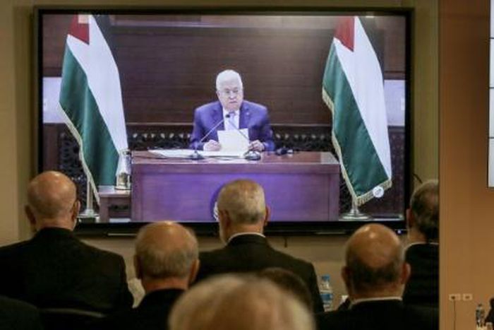 Palestinian factions gathered at their embassy in Beirut attend by video conference talks with president Mahmud Abbas (screen), while their counterparts in the West Bank watch speech of Hamas chief Ismail Haniyeh in Beirut