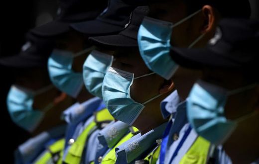 Masked police in front of the shuttered US consulate in Chengdu
