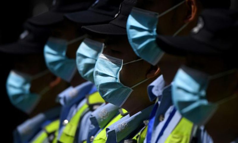 Masked police in front of the shuttered US consulate in Chengdu