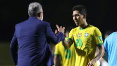 Brazil's coach Tite greets goal-scorer Roberto Firmino after defeating Venezuela 1-0 in their closed-door World Cup qualifier in Sao Paulo on Friday
