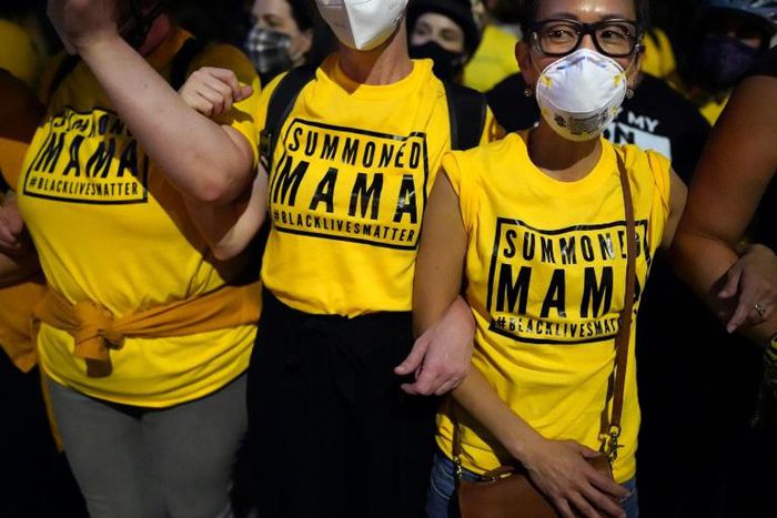PORTLAND, OR - JULY 21: Members of the "Wall of Moms", a group of protesters who form non-violent human barriers between police and the crowd, stand arm in arm during a protest at the Mark O. Hatfield U.S. Courthouse on July 21, 2020 in Portland, Orego...