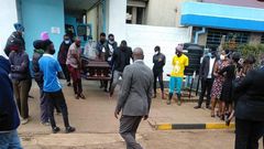 Ruth Matete picks the remains of her late husband Beloved John from the KNH morgue