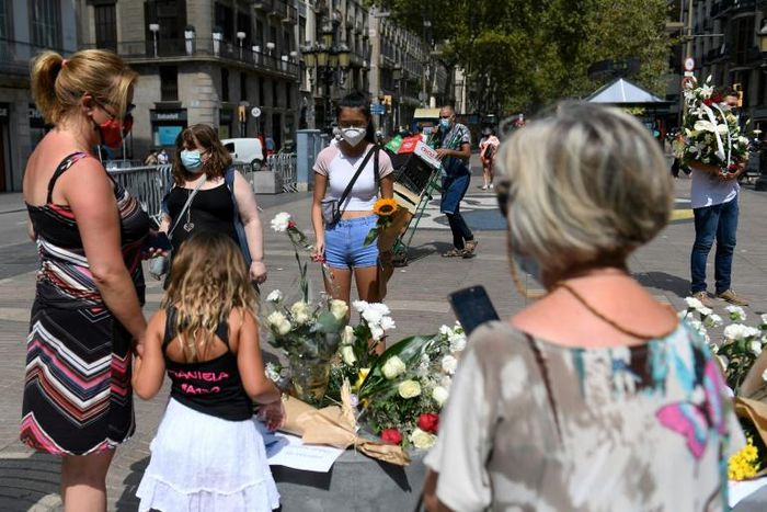 Relatives of the 16 dead laid white carnations on Barcelona's Las Ramblas boulevard where on August 17, 2017 a van mowed down pedestrians leaving behind a trail of bodies