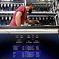 A bitcoin-mining computer and a screen showing bitcoin exchange rates at Bitminer Factory in Florence, Italy.